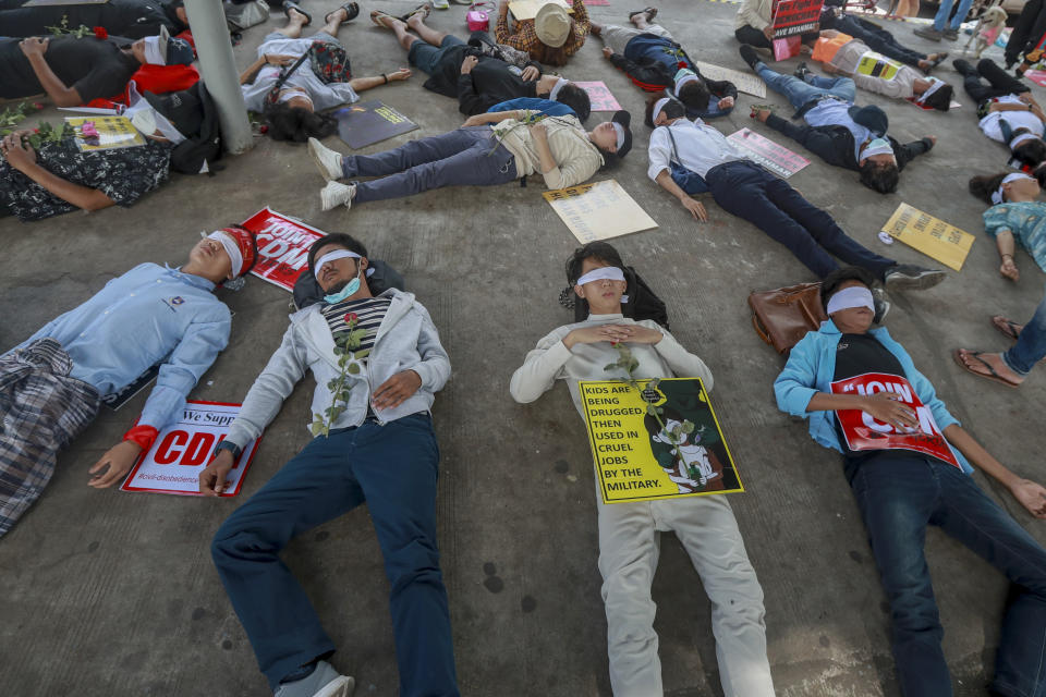 Demonstrators, with eyes blindfolded, lie down in the street to a protest a military coup in Yangon, Myanmar, Tuesday, Feb. 16, 2021. Security forces in Myanmar pointed guns toward anti-coup protesters and attacked them with sticks Monday, seeking to quell the large-scale demonstrations calling for the military junta that seized power this month to reinstate the elected government. (AP Photo)