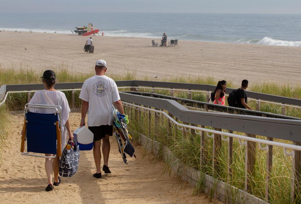 As Hurricane Henri heads up the coast just offshore, beachgoers and surfers try to salvage what they can of the weekend in Ortley Beach and Seaside Heights on August 21, 2021.