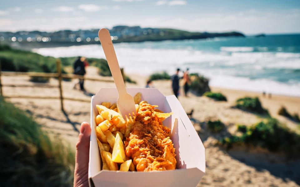 Fish & chips always taste better on the beach - Getty