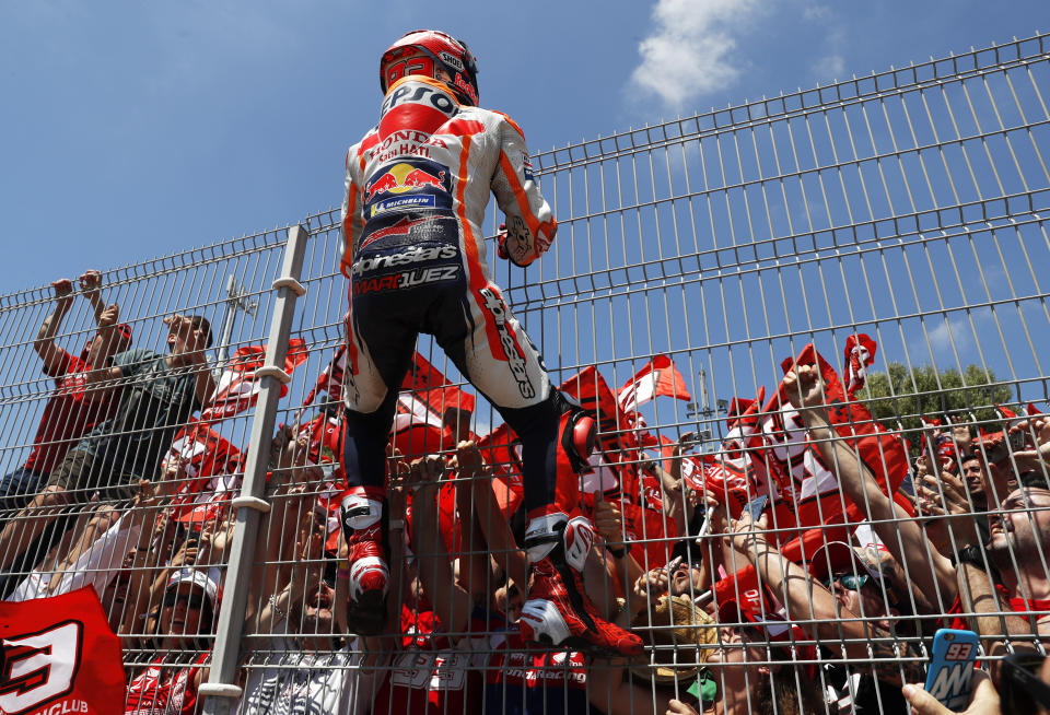 MotoGP rider Marc Marquez of Spain climbs on a fence to celebrate with the fans after winning the Spanish Motorcycle Grand Prix at the Angel Nieto racetrack in Jerez de la Frontera, Spain, Sunday, May 5, 2019. (AP Photo/Miguel Morenatti)