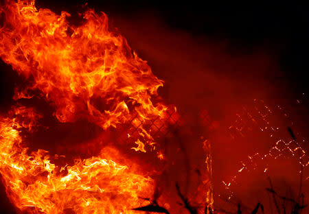 The Woolsey Fire burns in Malibu, California, U.S. November 9, 2018. The fire destroyed dozens of structures, forced thousands of evacuations and closed a major freeway. REUTERS/Eric Thayer