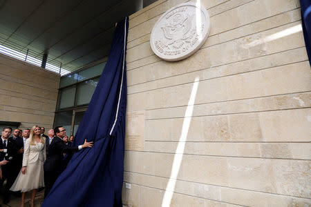 U.S. Treasury Secretary Steven Mnuchin unveils the seal and dedication plaque for the new U.S. embassy, as he stands next to Senior White House Adviser Ivanka Trump during the dedication ceremony of the new U.S. embassy in Jerusalem, May 14, 2018. REUTERS/Ronen Zvulun