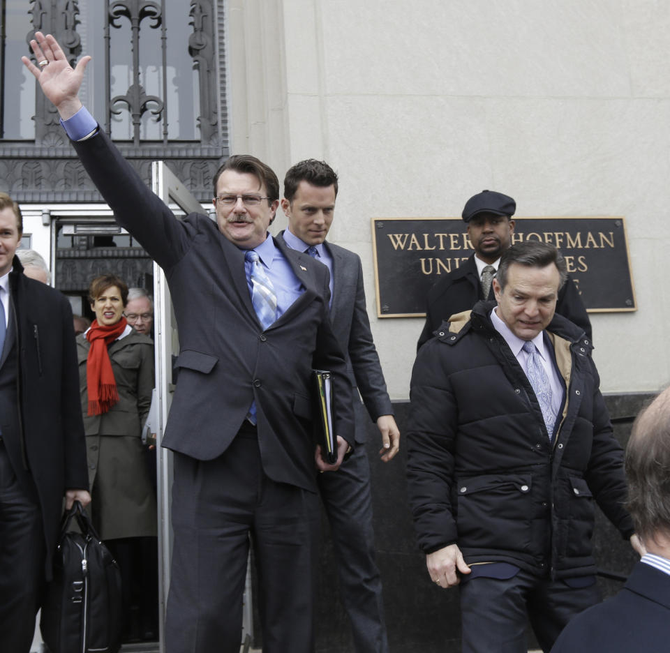 Plaintiff in the Bostic v. Rainey case, Tony London, waves to the crowd as he and his partner, Tim Bostic, right, leave Federal Court after a hearing on Virginia's ban on gay marriage in Norfolk, Va., Tuesday, Feb. 4, 2014. A federal judge heard arguments on whether Virginia's ban on gay marriage is unconstitutional. (AP Photo/Steve Helber)