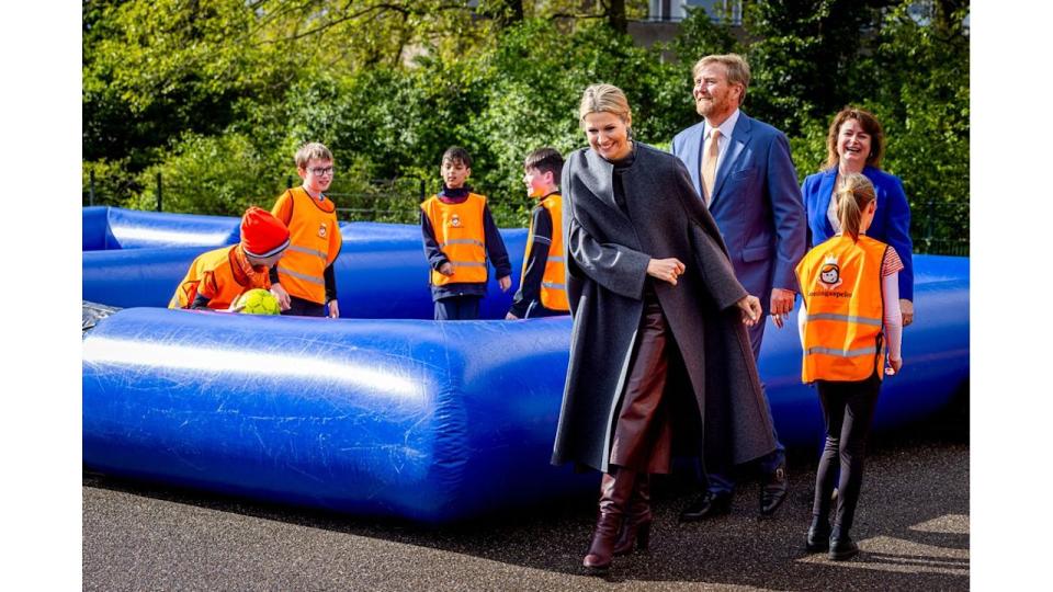 Queen Maxima in leather culottes and boots at school visit