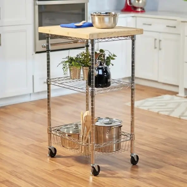 rolling kitchen cart with pots, pans, and cooking utensils