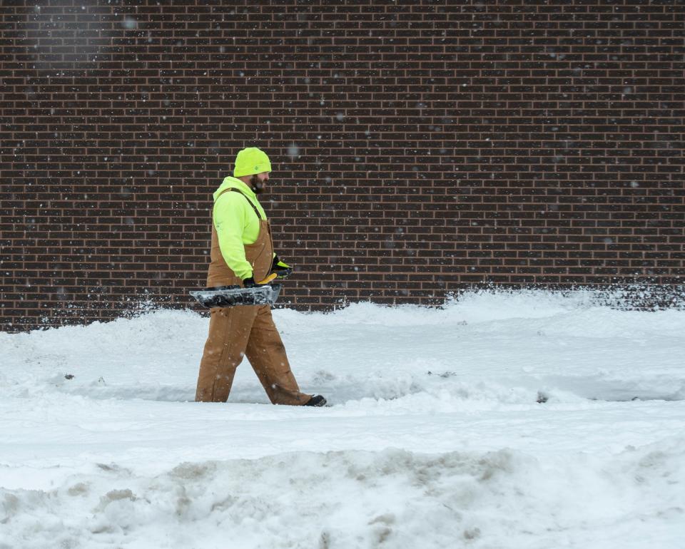 Kent sets out to clear sidewalks in the city limits and township. Public service department employee on E. Day street.