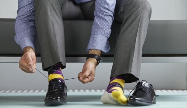 Man tying shoe laces