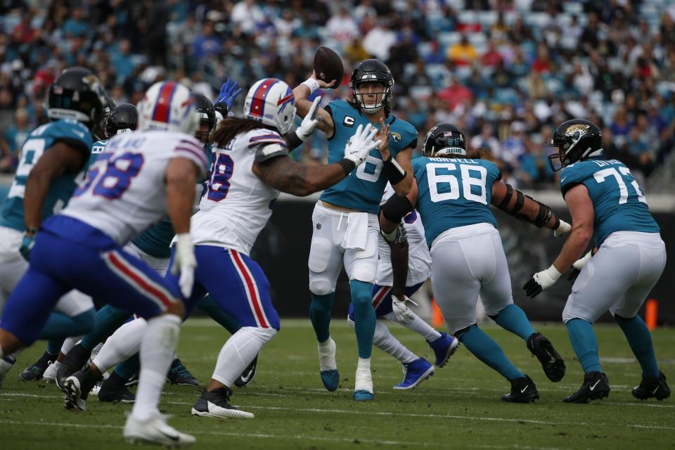 Jacksonville Jaguars quarterback Trevor Lawrence throws a pass over the Buffalo Bills defense Sunday, Nov. 7, 2021, in Jacksonville.