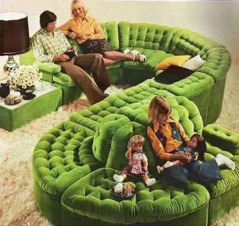 curvy green velvet couch in the 1970s