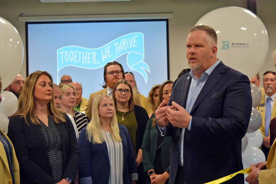 Mat Gass, Brightli central region president, speaks Tuesday at the joint Burrell and Clarity Health Care provider fair while joined by staff and Columbia Chamber of Commerce ambassadors.