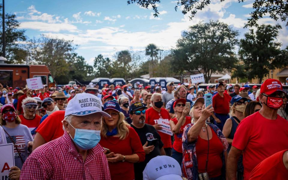 Attendees listen to US Vice President Mike Pence as he speaks at a rally - AFP