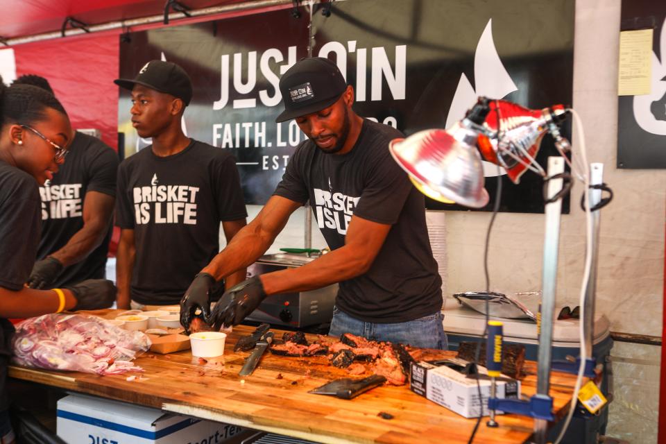 Just Q'in owner Matt Cuff cuts up some brisket for their booth at Taste of Cincinnati.