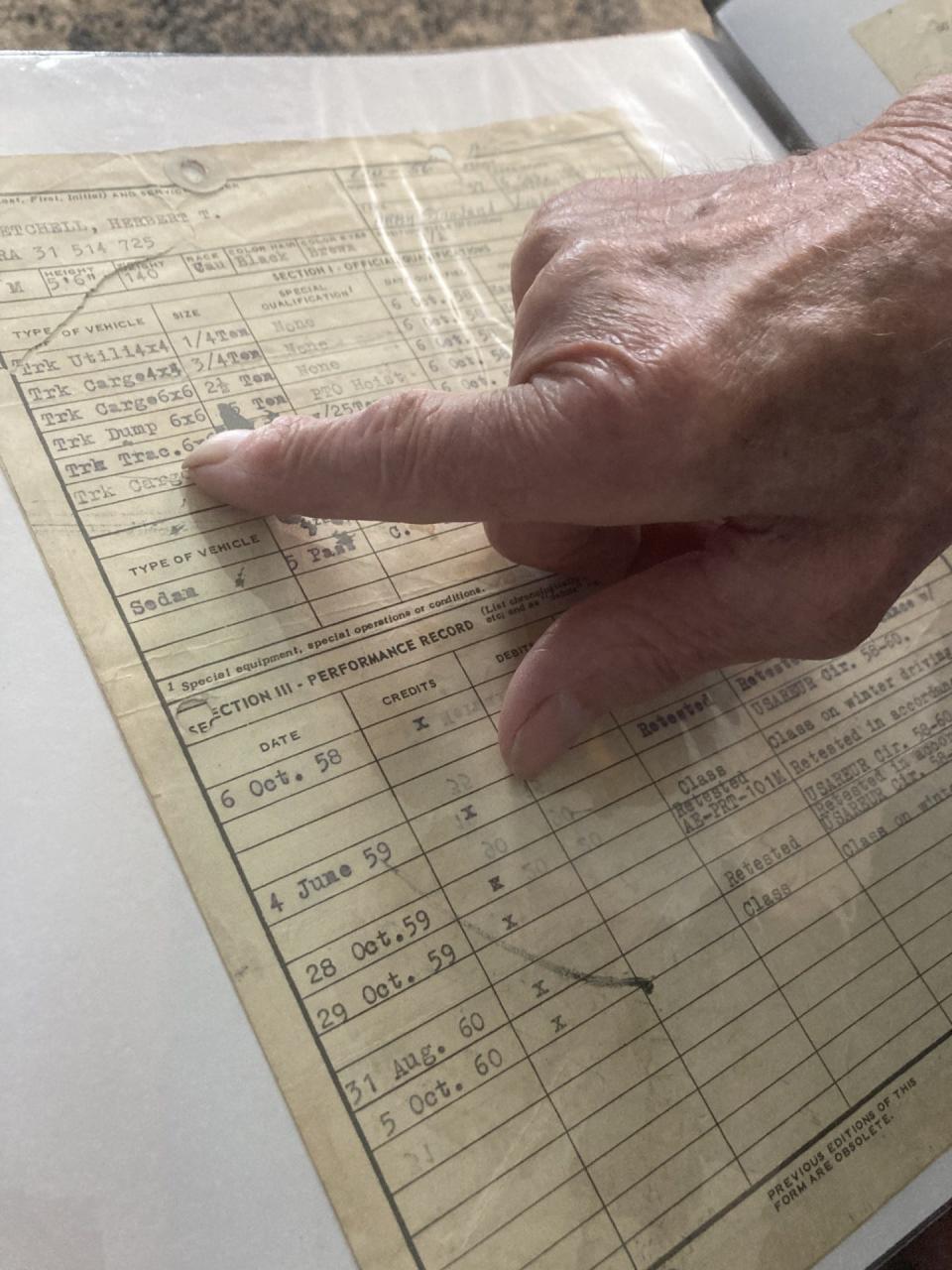 Retired Sgt. 1st Class Herbert Getchel shows the certification records he obtained to operate heavy equipment in the Army.