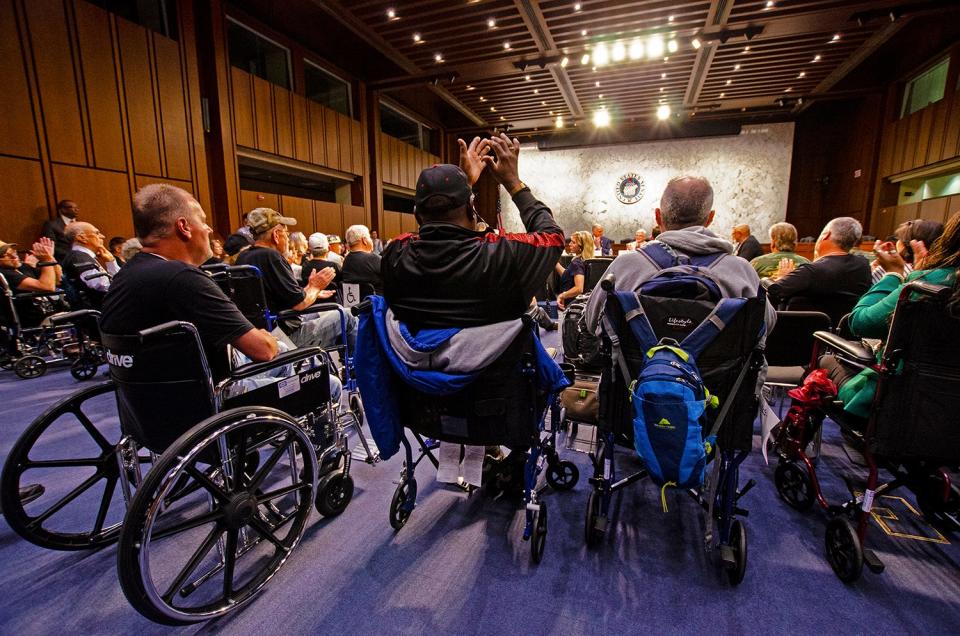 Retired coal miners, many of whom are suffering from black lung disease, cheer while senators and United Mine Workers of America representatives speak at a protest for health benefits on Capitol Hill in 2019.