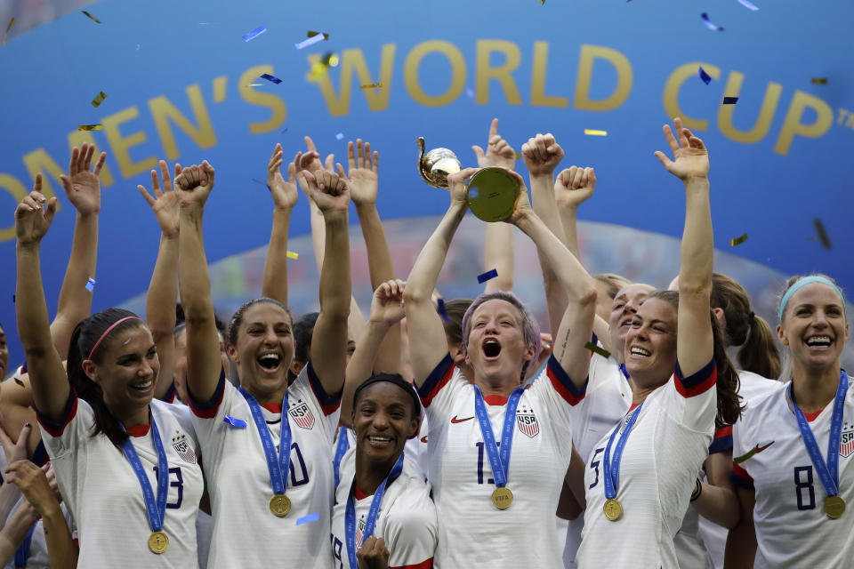 FILE - In this July 7, 2019, file photo, United States' Megan Rapinoe lifts up a trophy after winning the Women's World Cup final soccer match between U.S. and The Netherlands at the Stade de Lyon in Decines, outside Lyon, France. The 2023 Women's World Cup will be spread across nine cities in Australia and New Zealand. (AP Photo/Alessandra Tarantino, File)