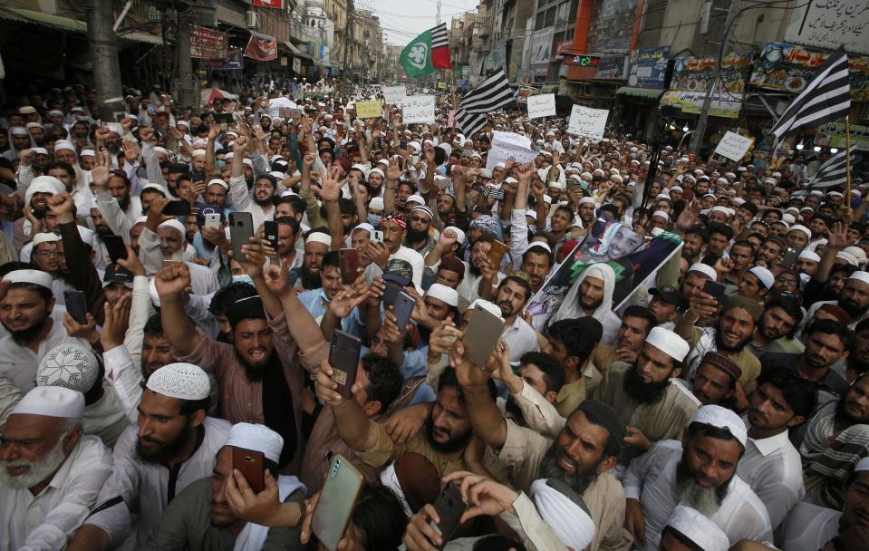 Supporters of a religious group chant slogan during a rally favoring the Khalid Khan, who gunned down Tahir Naseem in courtroom, in Peshawar, Pakistan, Friday, July 31, 2020. Naseem, a U.S. citizen, according to a U.S. State Department statement, was gunned down this week in a Pakistani courtroom while standing trial on a charge of blasphemy. (AP Photo/Muhammad Sajjad)