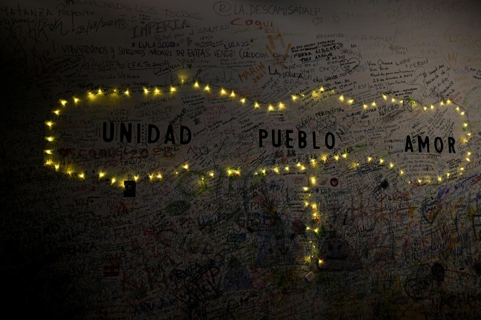 The words in Spanish " Unity, People, Love," are seen at a wall of "El Santa Evita" restaurant honoring Argentina's late former first lady Maria Eva Duarte de Peron, better known as "Evita" in Buenos Aires, Argentina, Sunday, July 24, 2022. Argentines commemorate the 70th anniversary of the death of their most famous first lady on Tuesday, Evita who died of cancer on July 26, 1952, at the age of 33. (AP Photo/Natacha Pisarenko)