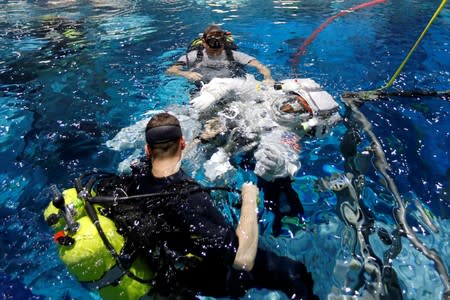 NASA Commercial Crew astronaut Sunita Williams enters the water at NASA's Neutral Buoyancy Laboratory (NBL) training facility near the Johnson Space Center in Houston