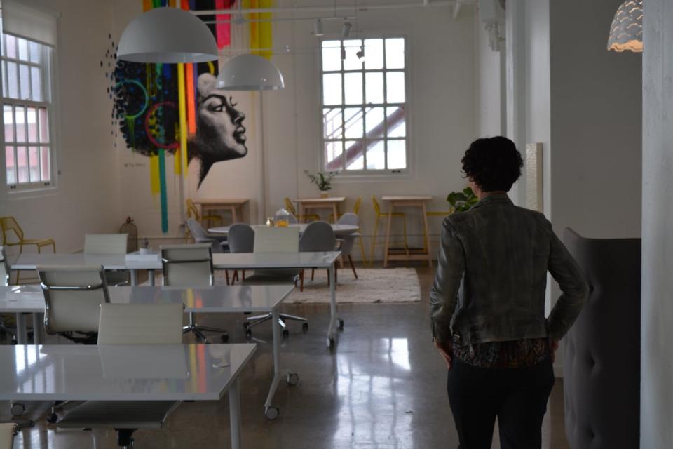 A woman walks through empty offices in a San Francisco coworking space (Josh Marcus / The Independent)