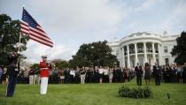 (L to R) U.S. President Barack Obama, U.S. first lady Michelle Obama and Vice President Joe Biden observe a moment of silence on the 13th anniversary of the 9/11 attacks at the White House in Washington September 11, 2014. REUTERS/Kevin Lamarque