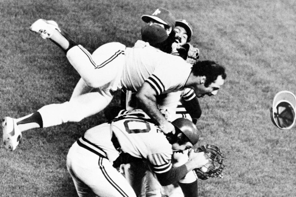 FILE- Oakland Athletic's Sal Bando, top, jumps on the heap as the jubilant A's whoop it up on the field after beating the Los Angeles Dodgers to win baseball's World Series, on Oct. 17, 1974, in Oakland, Calif. Bando, a three-time World Series champion with the Oakland Athletics and former Milwaukee Brewers executive, died Friday night, Jan. 20, 2023, in Oconomowoc, Wis., according to a statement from his family. He was 78. (AP Photo/File)