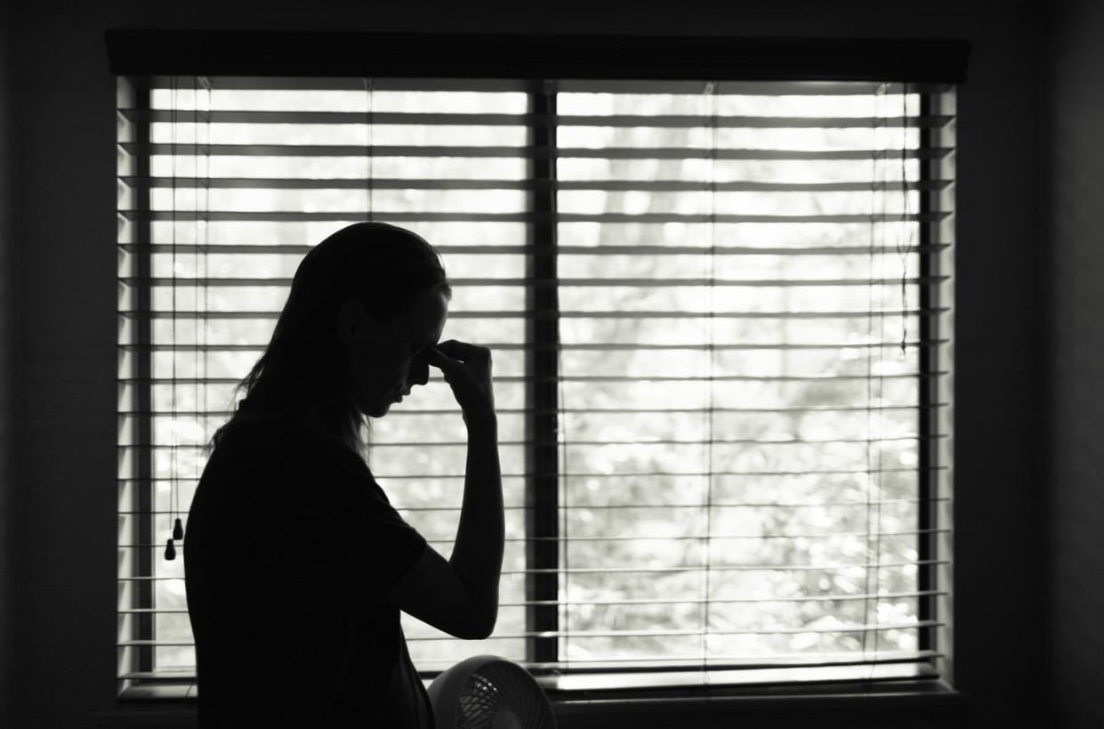 <span class="caption">During a pandemic, the victim is quarantined with the perpetrator.</span> <span class="attribution"><a class="link " href="https://www.gettyimages.com/detail/photo/tired-woman-standing-next-to-bedroom-window-royalty-free-image/1181078647?adppopup=true" rel="nofollow noopener" target="_blank" data-ylk="slk:kieferpix via Getty Images;elm:context_link;itc:0;sec:content-canvas"> kieferpix via Getty Images</a></span>