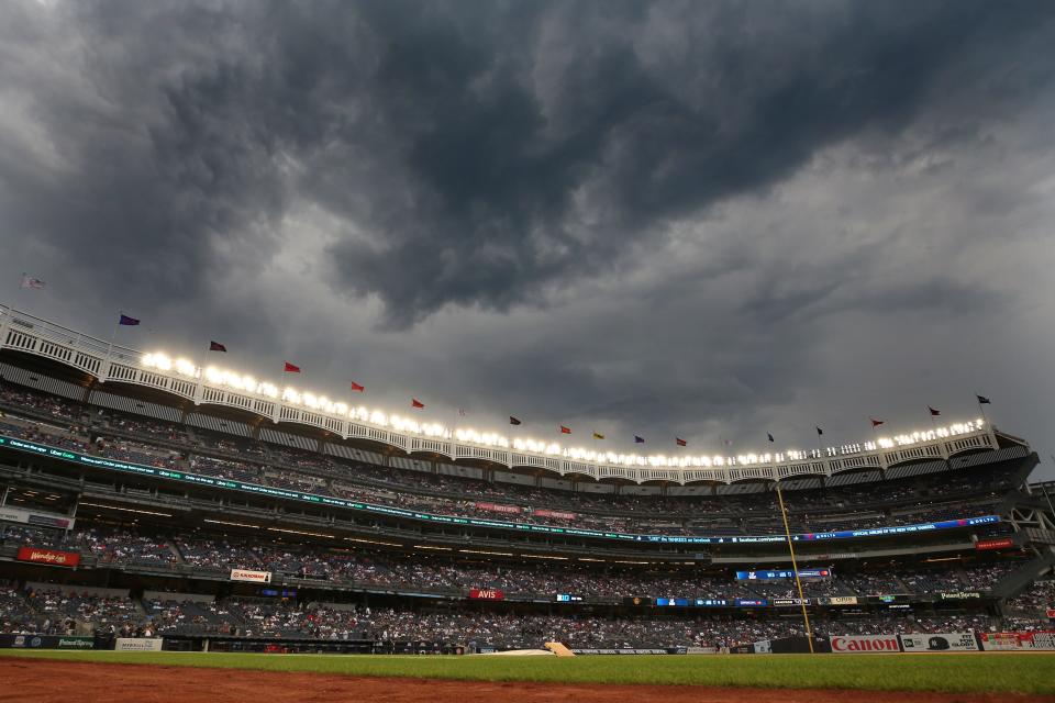 Jul 12, 2022; Bronx, New York, USA; General view of Yankee Stadium as storm clouds move in during a rain delay before a game between the New York Yankees and the Cincinnati Reds. Mandatory Credit: Brad Penner-USA TODAY Sports