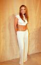 <p>A classic nineties look of low-slung trousers and a crop top, in white. </p>