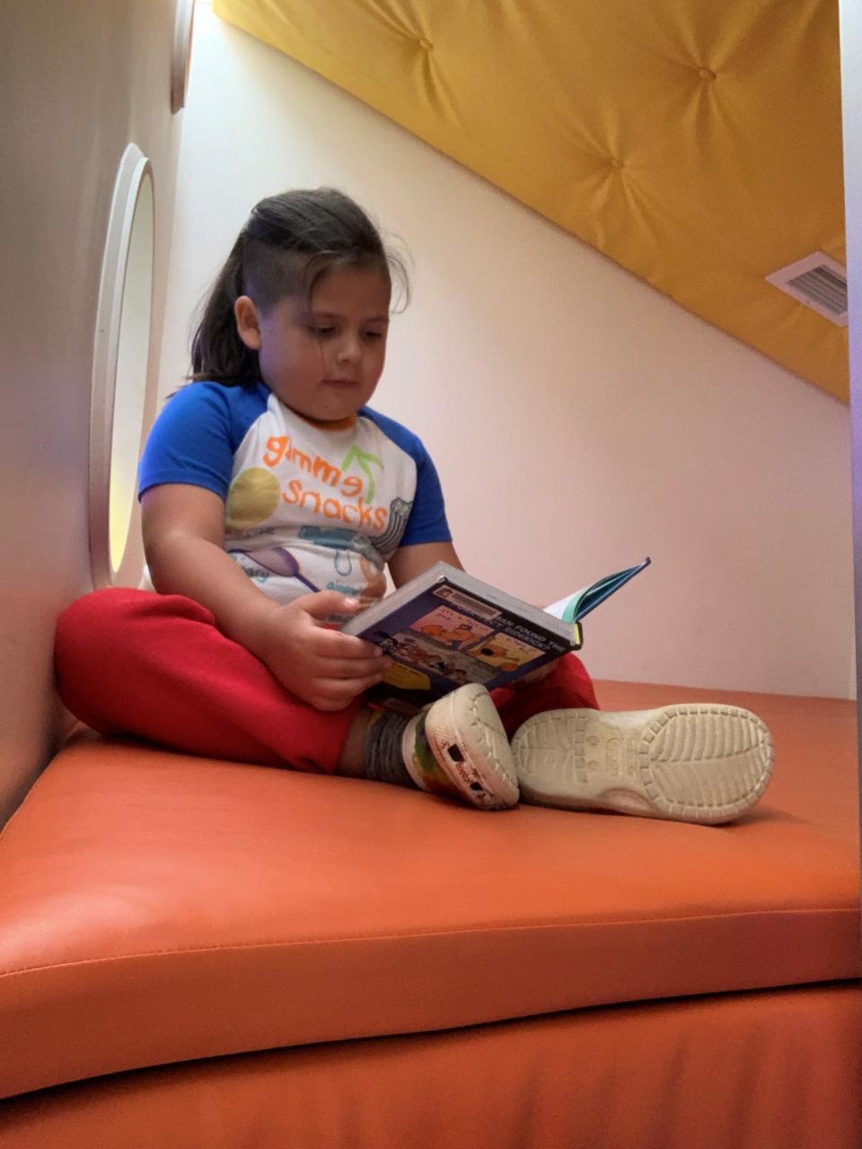 Ezra Cisneros enjoying the reading nook at the Middletown Branch of the Louisville Free Public Library