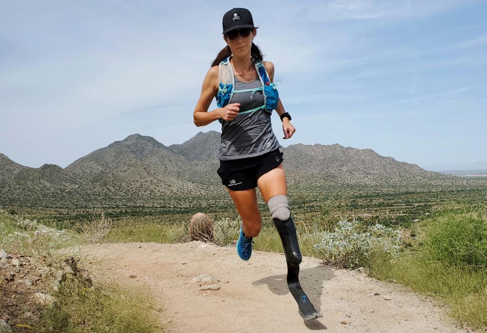 In this image provided by Edwin Broersma, marathoner Jacky Hunt-Broersma trains on Aug. 28, 2021 at San Tan Mountain Regional Park, in San Tan Valley, Arizona. Hunt-Broersma lost her left leg below the knee to a rare form of cancer.