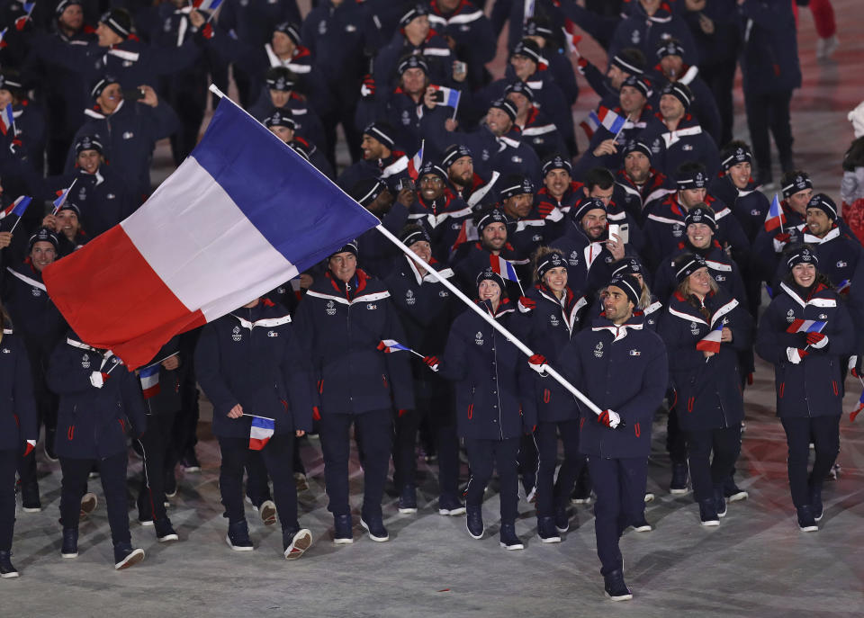 <p>Martin Fourcade carries the flag of France during the opening ceremony of the 2018 Winter Olympics in Pyeongchang, South Korea, Friday, Feb. 9, 2018. (AP Photo/Michael Sohn) </p>