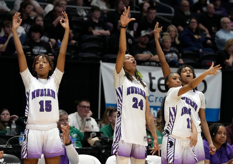 Africentric's Aries Grant (15), Kamryn Grant (24), Shaunie Little (11) and Samairah Thompson (5) celebrate a 3-point basket during the Nubians' Division III state semifinal win Thursday in Dayton.