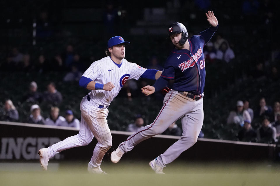 Chicago Cubs' Nico Hoerner, left, catches Minnesota Twins' Ryan Jeffers trying to steal second during the ninth inning of a baseball game Wednesday, Sept. 22, 2021, in Chicago. The Twins won 5-4. (AP Photo/Charles Rex Arbogast)