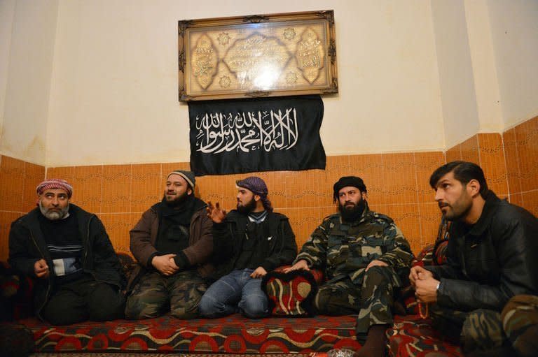 Syrian rebels rest in their compound in Aleppo's old city on January 16, 2013. More than 100 civilians have been killed in a new "massacre" in Syria, a watchdog said Thursday, as Russia slammed the United States for blaming deadly blasts at a university campus on the Damascus regime