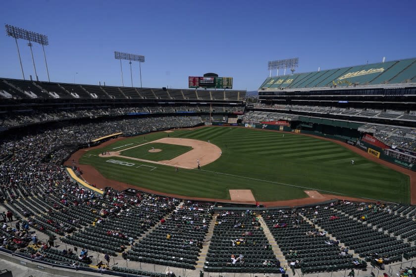 Fans watch as Oakland Athletics' James Kaprielian pitches against the Los Angeles Angels during the sixth inning of a baseball game in Oakland, Calif., Tuesday, July 20, 2021. (AP Photo/Jeff Chiu)