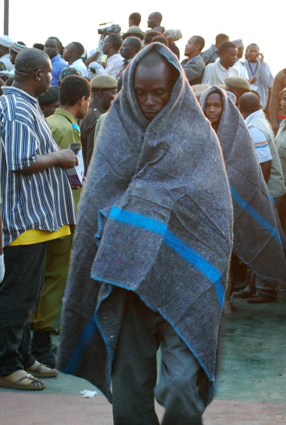 Wrapped in blankets survivors of the MV Karama Star Gate, ferry accident are brought into Malindi port in Zanzibar Wednesday July 18, 2012. A Zanzibar official says at least a dozen people were killed in the ferry accident off the coast of Tanzania's island region of Zanzibar. Mwinyihaji Makame, a deputy minister in the office of the president, said Wednesday it remained unclear how many passengers were on board, but witnesses said the ferry carried more than 200 people when it sank. The ferry sailed from the Tanzanian port city of Dar es Salaam and was headed for Zanzibar, which is popular with tourists.(AP Photo)