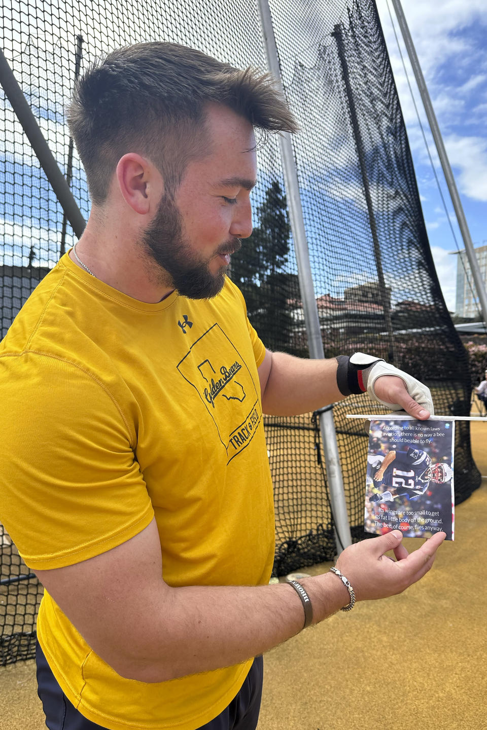 Kegan Schroeter holds a flag showing former NFL football quarterback Tom Brady that he uses to mark his throws during a practice in Berkeley, Calif., Friday, April 12, 2024. (AP Photo/Janie McCauley)