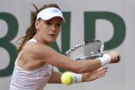 Agnieszka Radwanska's defeat was only the third time in 34 Grand Slam tournaments that 26-year-old Radwanska had lost in the first round returns the ball to Germany's Annika Beck during the women's first round of the Roland Garros 2015 French Tennis Open in Paris on May 25, 2015. AFP PHOTO / DOMINIQUE FAGET