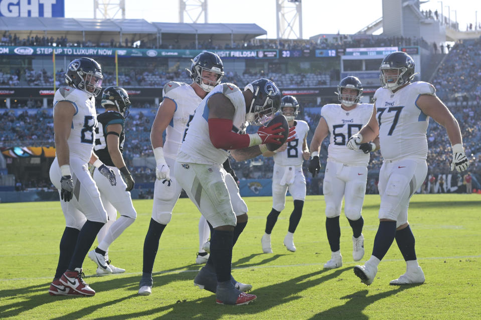 Tennessee Titans defensive tackle Jeffery Simmons, center, celebrates a touchdown with teammates during the second half of an NFL football game against the Jacksonville Jaguars, Sunday, Nov. 19, 2023, in Jacksonville, Fla. (AP Photo/Phelan M. Ebenhack)