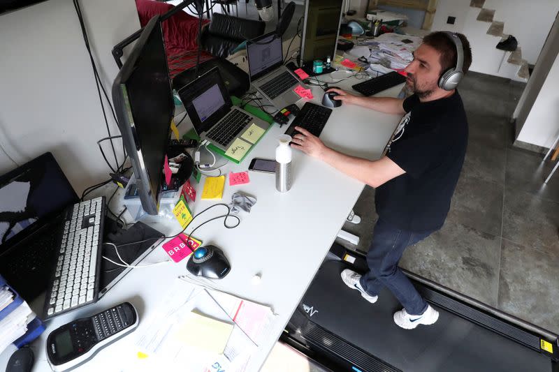 Belgian Yves Hanoulle, IT professional, walks on a treadmill installed under his desk, with the average of 20km daily, as he works in his home in Ghent