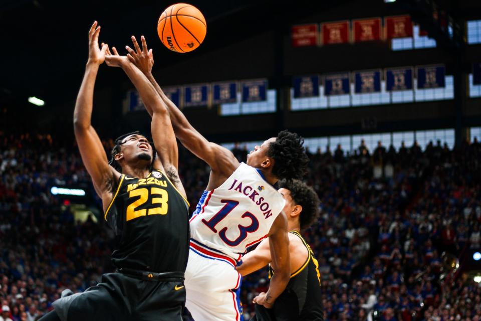Missouri foward Aidan Shaw (23) and Kansas forward Elmarko Jackson (13) fight for a rebound during a college basketball game at the Allen Fieldhouse on Dec. 9, 2023, in Lawrence, Kan.