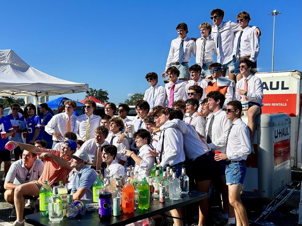 Members of the University of Florida Sigma Chi chapter pose for a group picture at their tailgate party site at EverBank Stadium on Saturday before the Florida-Georgia game.