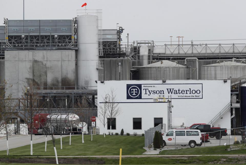 In this May 1, 2020, file photo, vehicles sit outside the Tyson Foods plant in Waterloo, Iowa. Civil rights attorney Tom Frerichs on Thursday June 25, 2020, filed a lawsuit on behalf of the estates of three Tyson Foods workers at its pork processing plant in Waterloo who died after contracting coronavirus. The lawsuit alleges the company knowingly put employees at risk during an outbreak and lied to keep them on the job. (AP Photo/Charlie Neibergall)