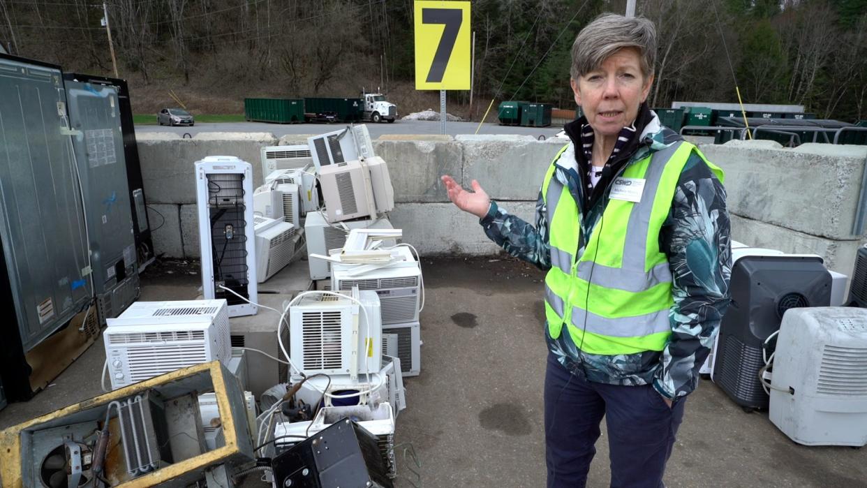 Michele Morris of Chittenden Solid Waste District stands next to a pile of appliances at CSWD's Williston drop-off center. Freezers, air conditioners, and other appliances that contain refrigerants cannot go in the trash or the blue recycling bin in Vermont. They can be brought to CSWD drop-off centers.