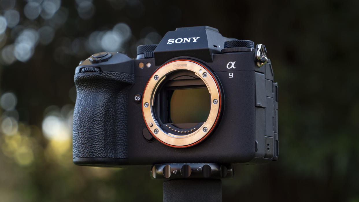  Sony A9 III camera outside with background foliage, no lens attached. 