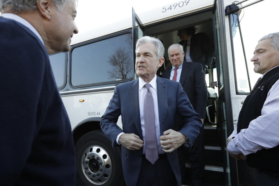 FILE - In this Nov. 25, 2019, file photo Federal Reserve Board Chair Jerome Powell, center, steps off a bus and greets people during tour of East Hartford, Conn. On Wednesday, Dec. 11, the Federal Reserve issues a statement and economic projections, followed by a news conference with Powell. (AP Photo/Steven Senne, File)