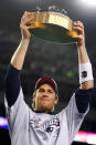 Tom Brady #12 of the New England Patriots celebrates with the Lamar Hunt Trophy after defeating the San Diego Chargers by a score of 21-12 to win the AFC Championship Game on January 20, 2008 at Gillette Stadium in Foxboro, Massachusetts. (Photo by Elsa/Getty Images)