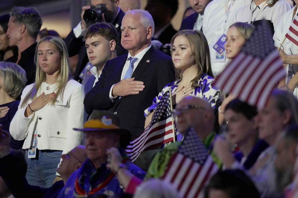 Vice presidential nominee Tim Walz during the Star Spangled Banner during the final day of the Democratic National Convention at the United Center.