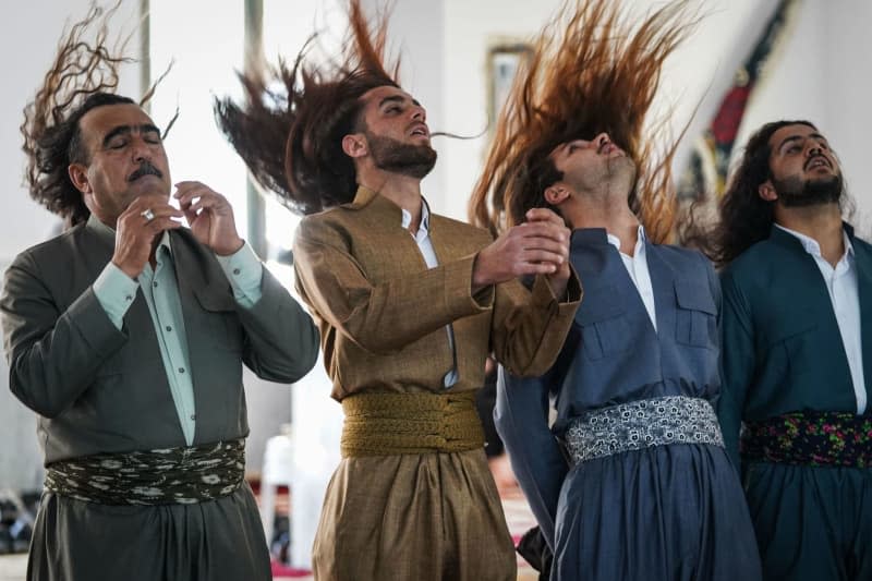 Iraqi Muslim Kurds, who are following the Sufi order of the al-Aliyah al-Qadiriyah al-Waliyaniyah, perform Dhikr (remembrance of Allah) rituals as they celebrate Eid al-Fitr, which marks the end of the Muslim's holy fasting month of Ramadan, in the town of Akre east of the the Kurdish city of Dohuk. Ismael Adnan/dpa