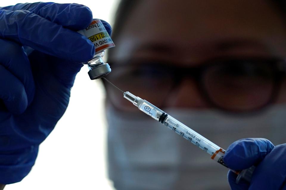 Carolyn Ruyle, a registered nurse at Lurie Children's Hospital in Chicago, prepares a dose of the Pfizer-BioNTech COVID-19 vaccine on Nov. 5.